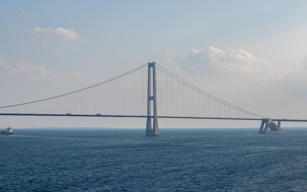 The suspension span of the Great Belt Bridge with a ship passing on the Great Belt
