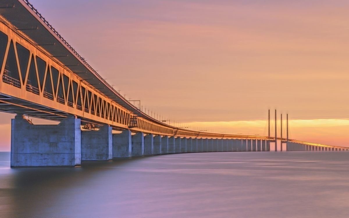 Sunset behind the Øresund Bridge with the pylons on the horizon